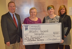 people presenting large check